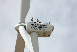 Wind students from both Mesalands Community College and Clovis Community College, under the direction of (Left) Terrill Stowe, Wind Energy Technology Instructor at Mesalands, climb the College’s wind turbine 
