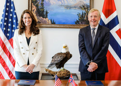 Kate MacGregor and a white male Norwegian official stand in front of their national flags.Deputy Secretary Kate MacGregor and Norway's Ambassador to the United States Kåre R. Aas at the signing ceremony (Image: Faith Vander Voort, U.S. DOI)