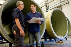 Workers at the Vestas blade plant in Windsor, Colo., discuss production issues. 